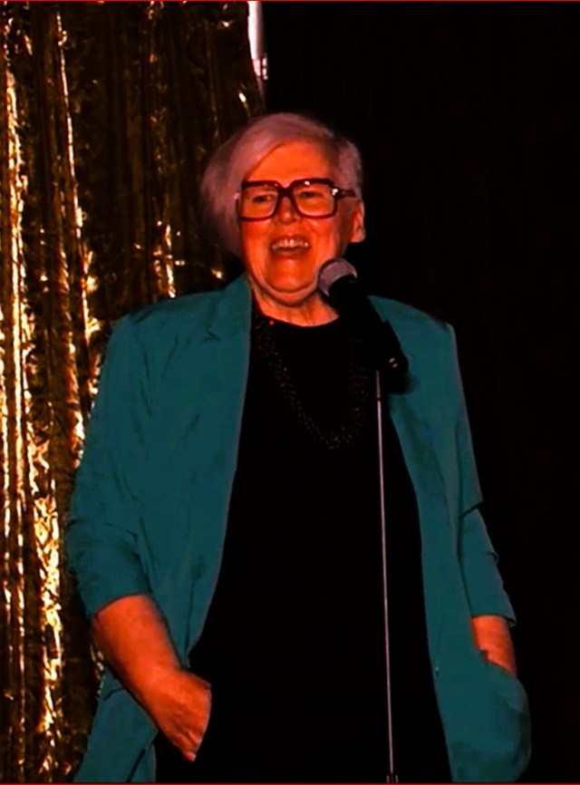 photo of Kate Nonesuch at a microphone